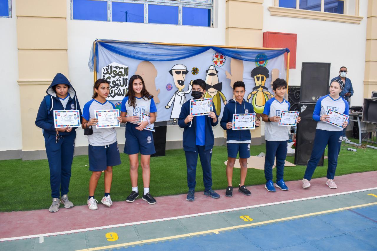 IVY STEM International School students participating in an outdoor event, holding certificates of achievement
